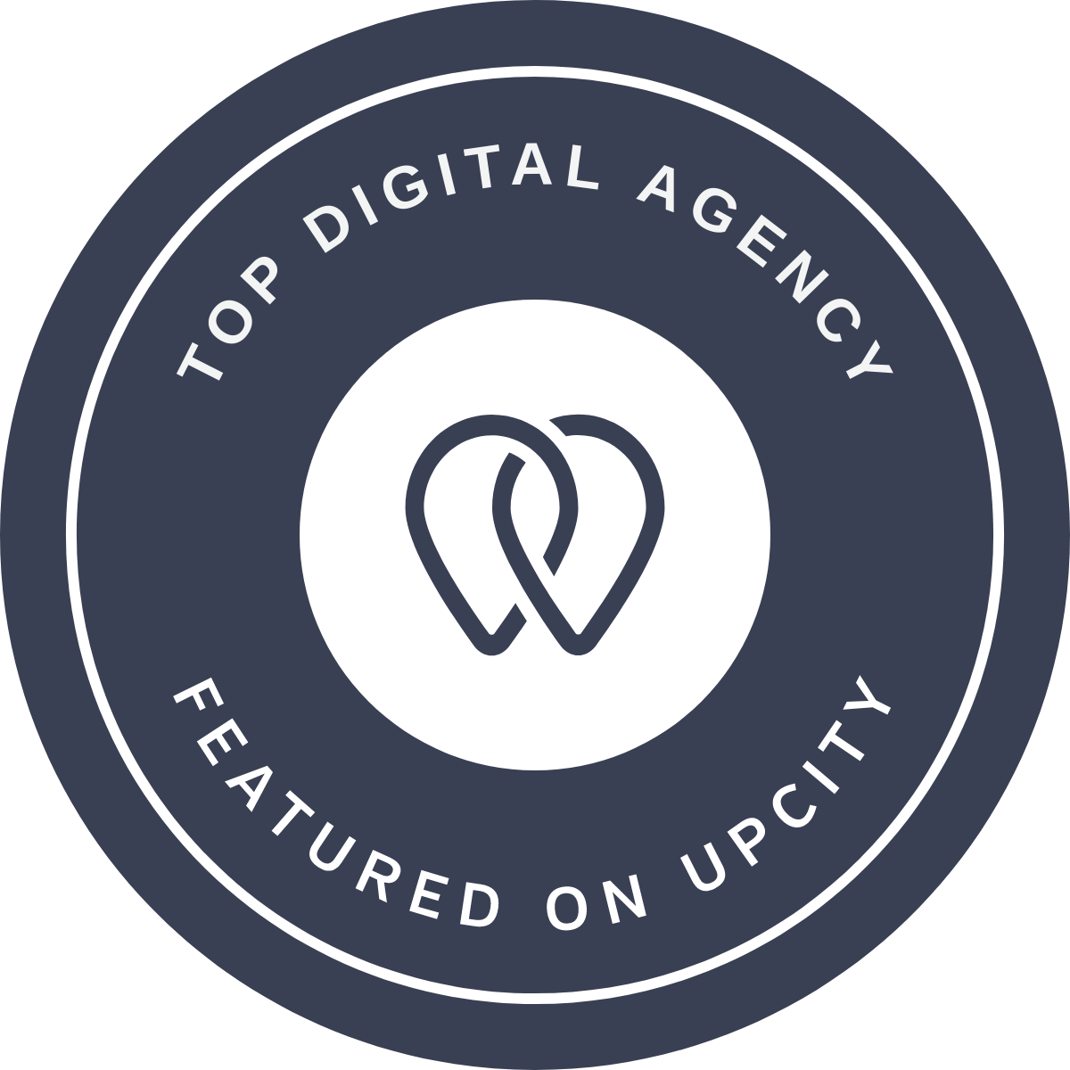 A round badge with circle borders and the text "Top Digital Agency Featured on UpCity" surrounding an abstract heart-shaped logo in the center.